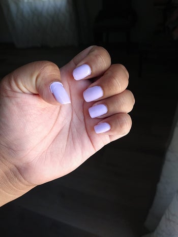 a reviewer wearing the purple polish