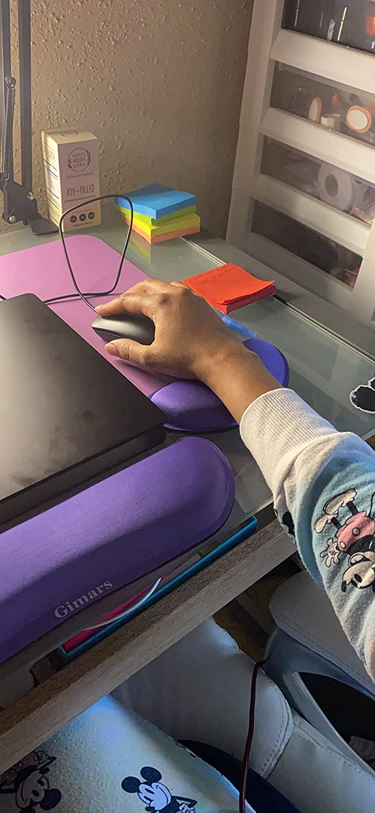 a close up of a reviewer's purple wrist pads