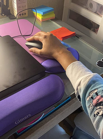 a close up of a reviewer's purple wrist pads