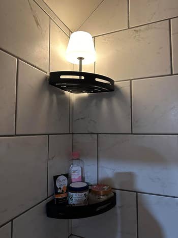 Bathroom ablution country support with a glowing lamp, holding skincare products and a soap container