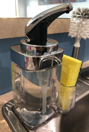 Reviewer image of clear soap dispenser with yellow sponge