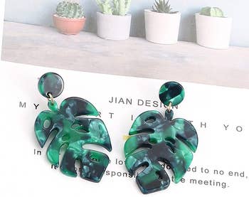 monstera shaped drop earrings in green