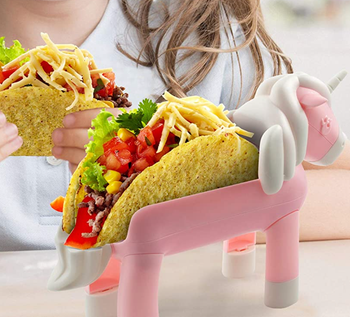 The pink unicorn shaped holder with a taco in it 