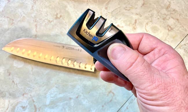 image of reviewer holding the sharpener up above a knife