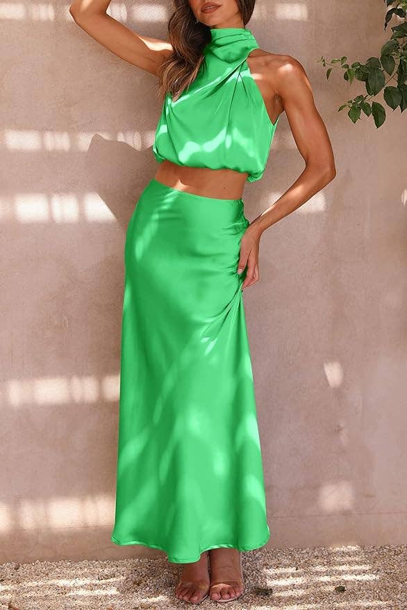 Woman in a chic, halter-neck green crop top with matching skirt, ideal for summer fashion