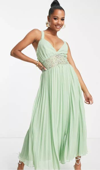 model posing in mint green maxi dress with lace detailing