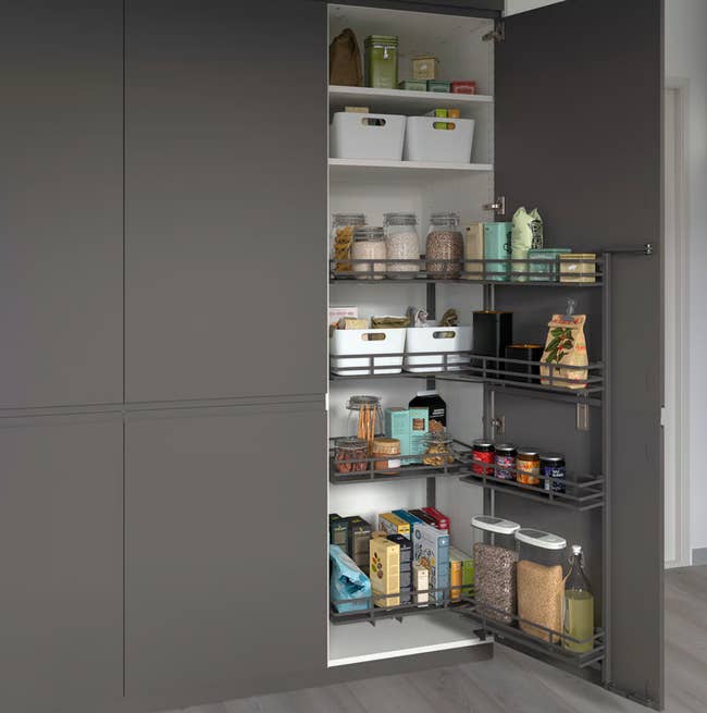 Open room  pantry filled with organized containers, jars, and assorted  nutrient  items connected  pull-out shelves