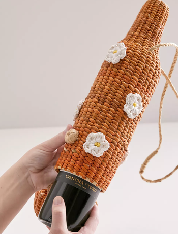 Model putting a bottle of wine in the holder