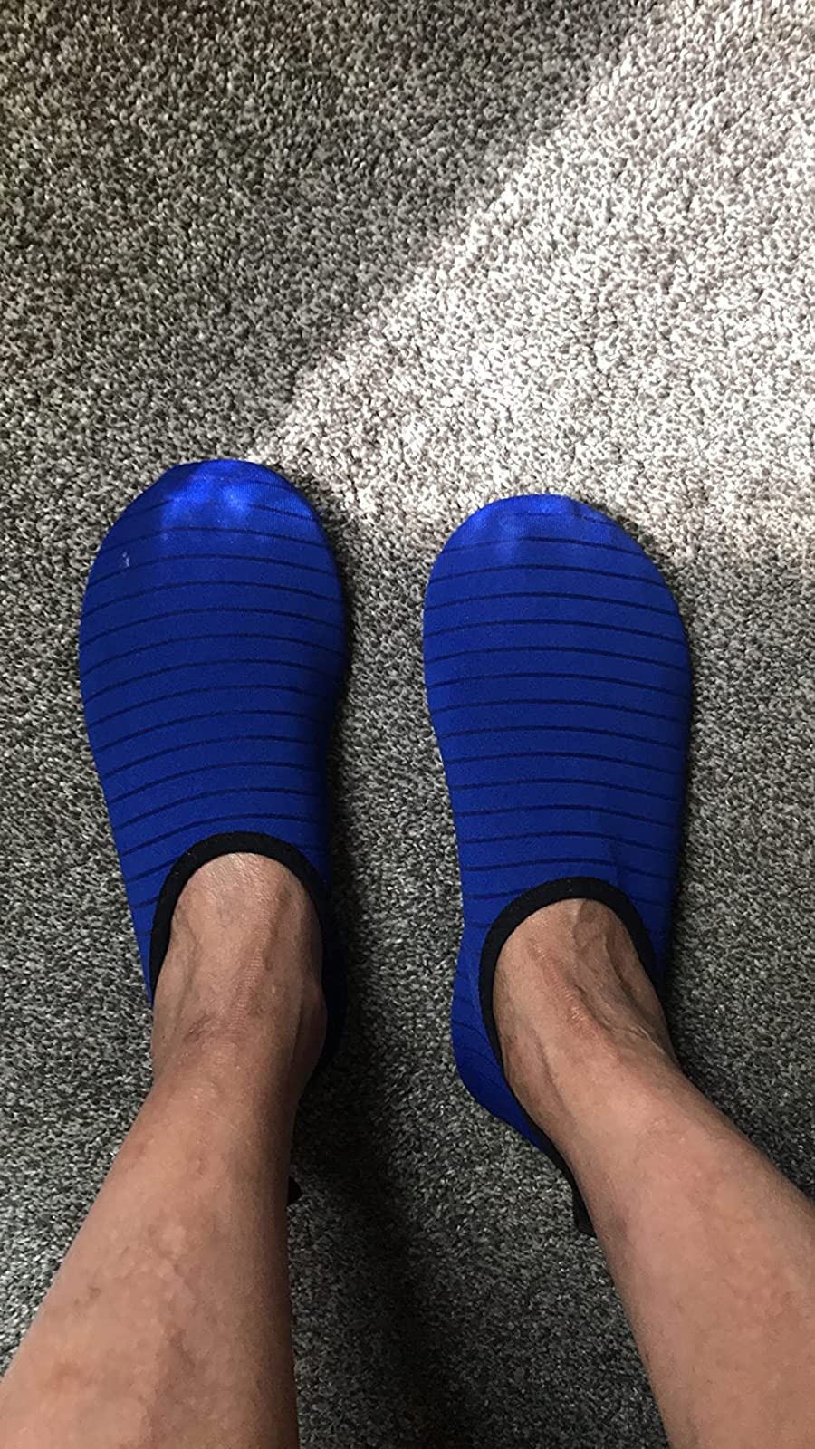 a reviewer wearing the slip-on shoes in blue 