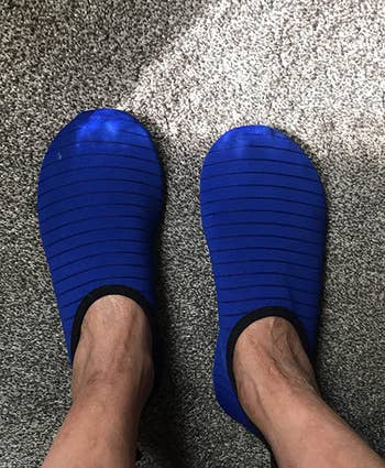 a reviewer wearing the slip-on shoes in blue 