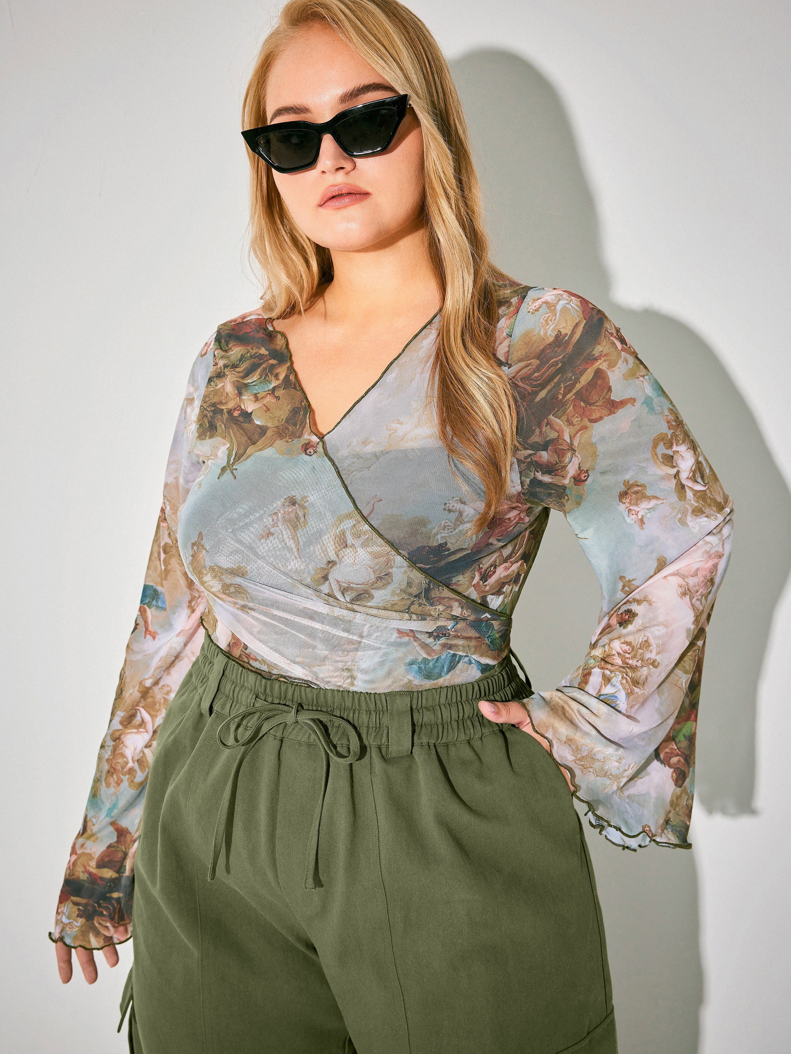 a model wearing the bell sleeve top