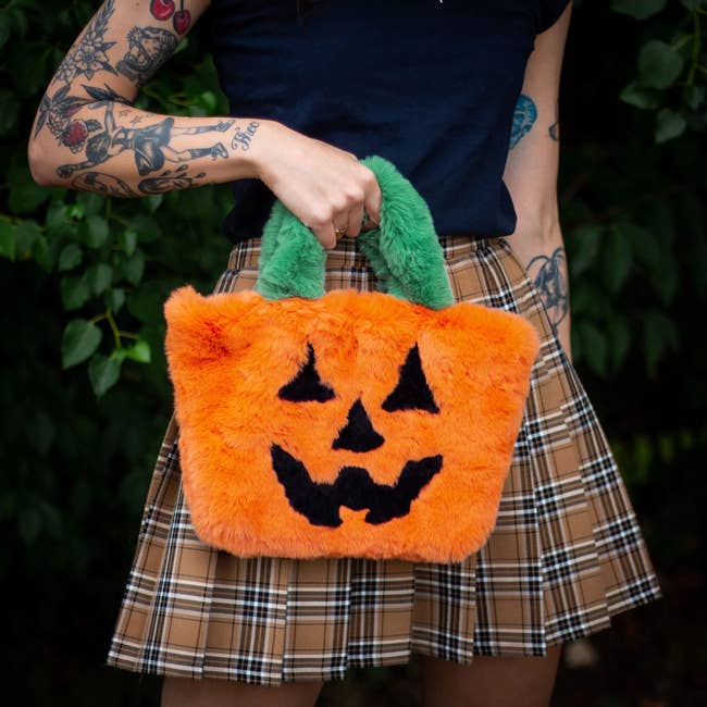 model holding pumpkin purse 