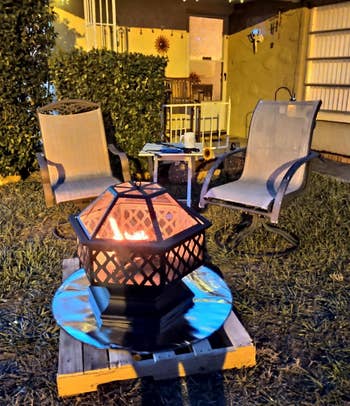 a fire pit on the fire pad on top of a wood pallet