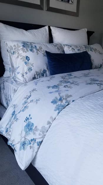 another reviewers bed with the blue floral sheets on it