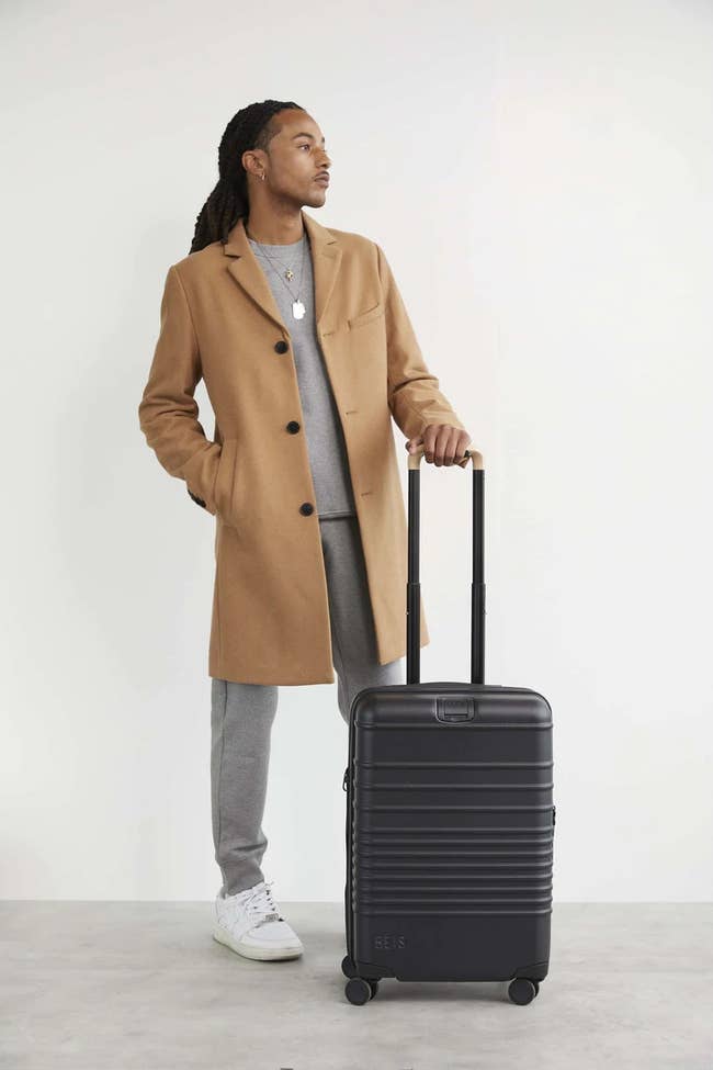 model with a roller suitcase