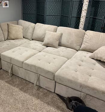 a reviewer close up of the beige sleeper couch