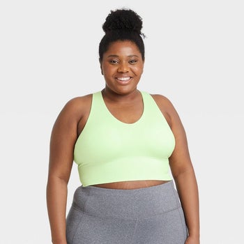 model in light green longline seamless sports bra and gray leggings