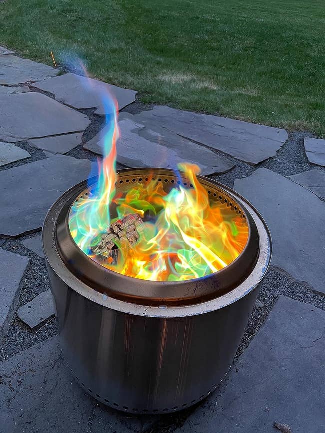reviewer image of colorful flames coming forth from a fire pit