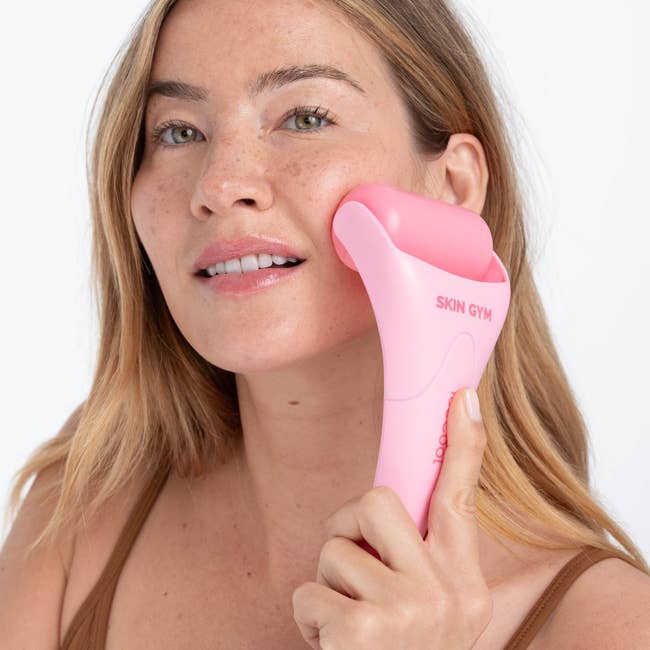Person utilizing a facial roller, labeled