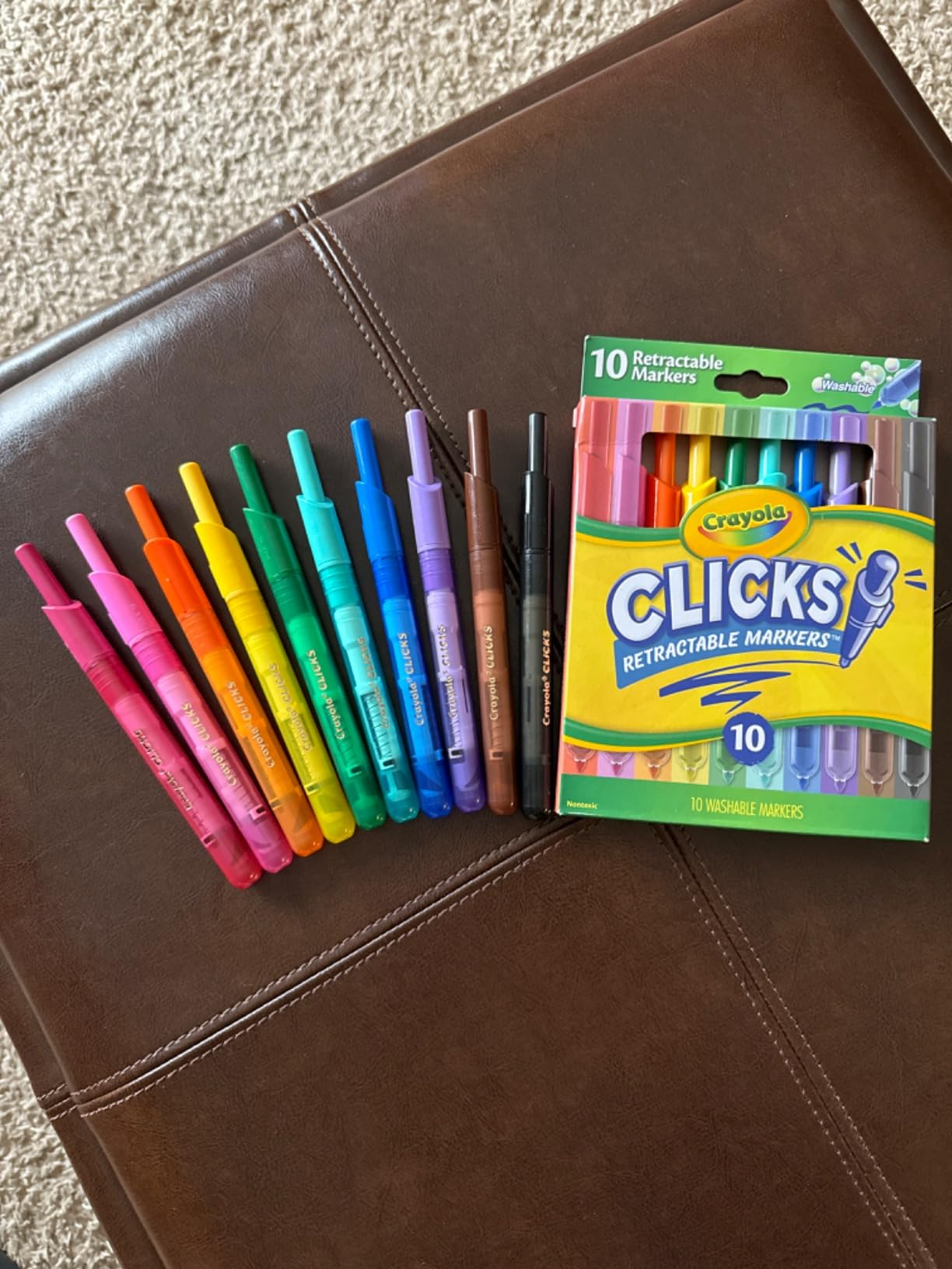 Crayola Clicks retractable markers, 10-pack, displayed connected  a brownish  surface