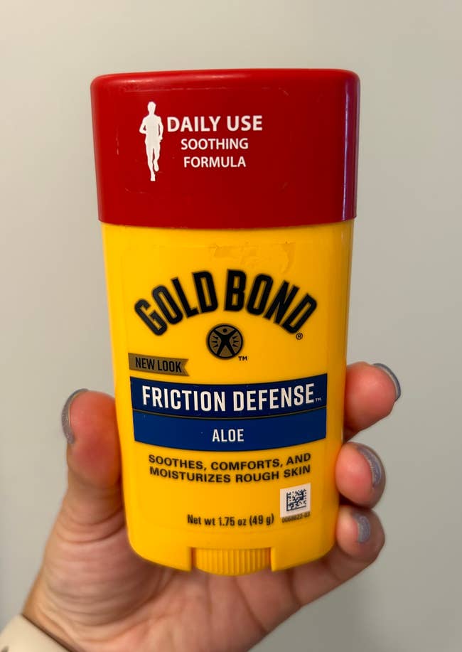 buzzfeed editor holding the gold bond friction defense stick