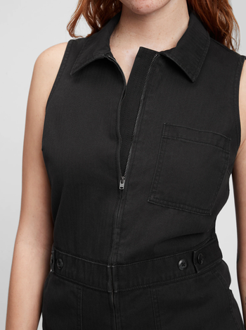 close up of a model in the black jumpsuit showing the front zipper and collar