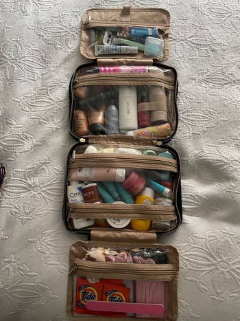 various toiletry products organized in four pockets of the bag