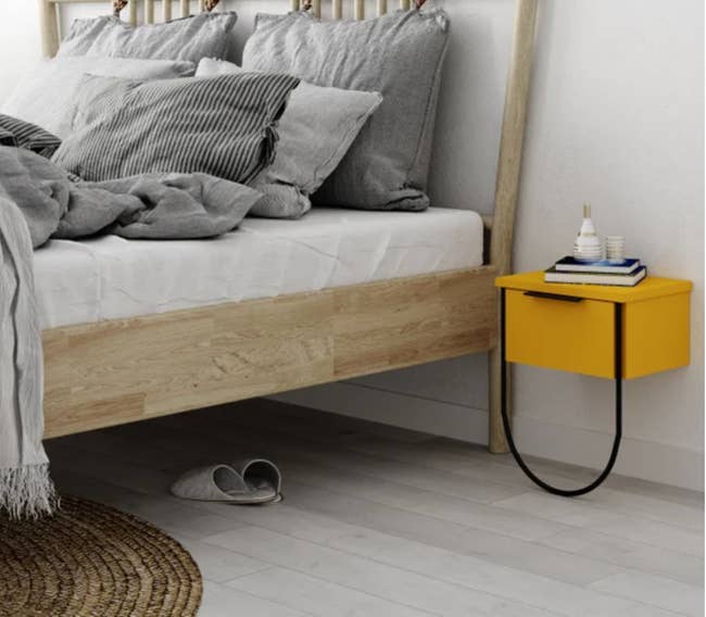 yellow wall-mounted nightstand in a bedroom