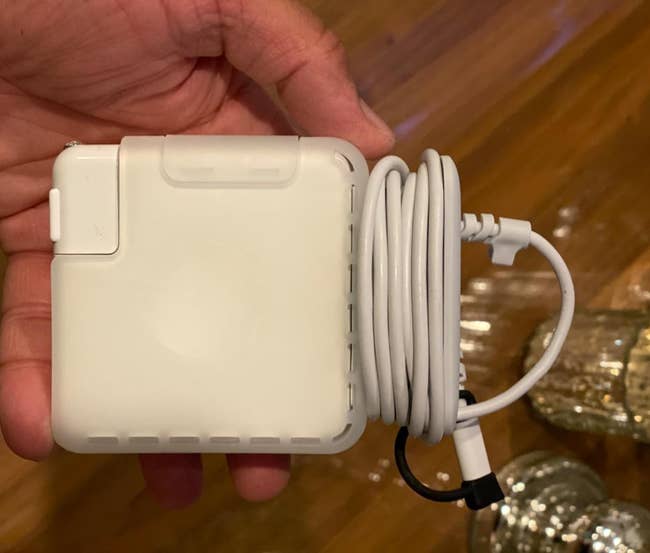 a reviewer holding the charger inside the case with the 