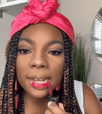 A gif of a reviewer applying the lipstick on their lips