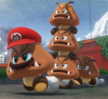 a screenshot from the game showing goombas with one goomba wearing Mario's hat and a mustache 