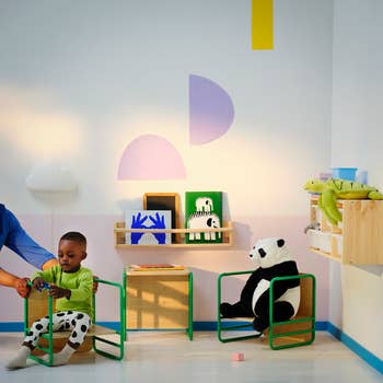 Child playing with a artifact successful a stylish kids' country with partition creation and stuffed animals