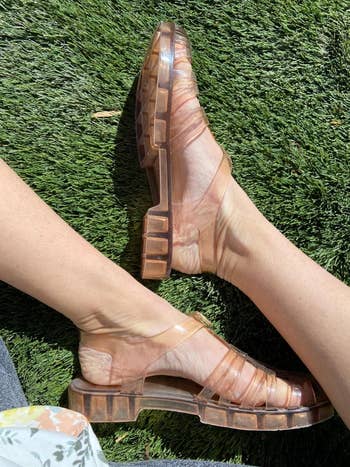 Transparent jelly sandals connected  feet, posed connected  grass, showcasing casual summertime  footwear suitable for outdoor activities oregon  shopping