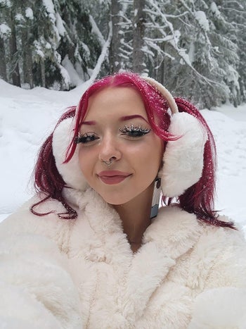 reviewer selfie wearing white ear muffs