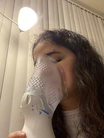 a reviewer shown using the inhaler