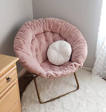 reviewer's pink chair holding a white pillow