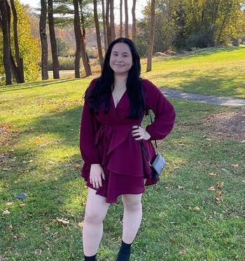 reviewer wearing the burgundy dress with boots