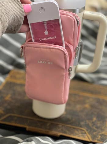 a reviewer's pink touchland hand sanitizer in a pouch