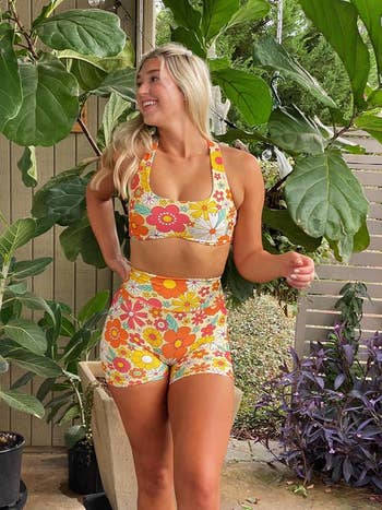 Person wearing a floral diversion matching set, posing outdoors among plants