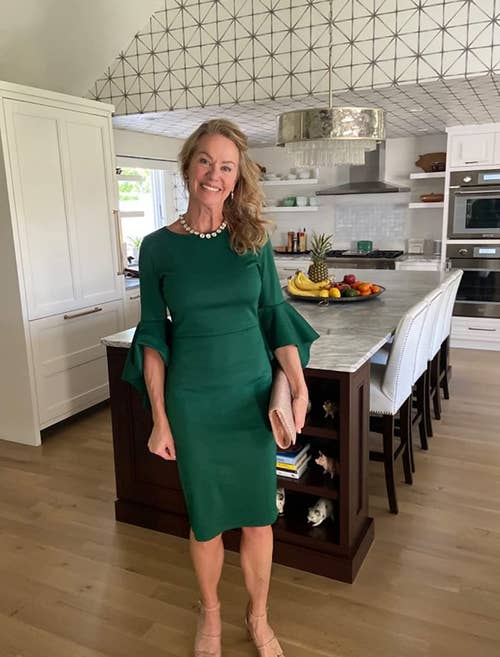 Reviewer is wearing the pencil dress with bell sleeves in green