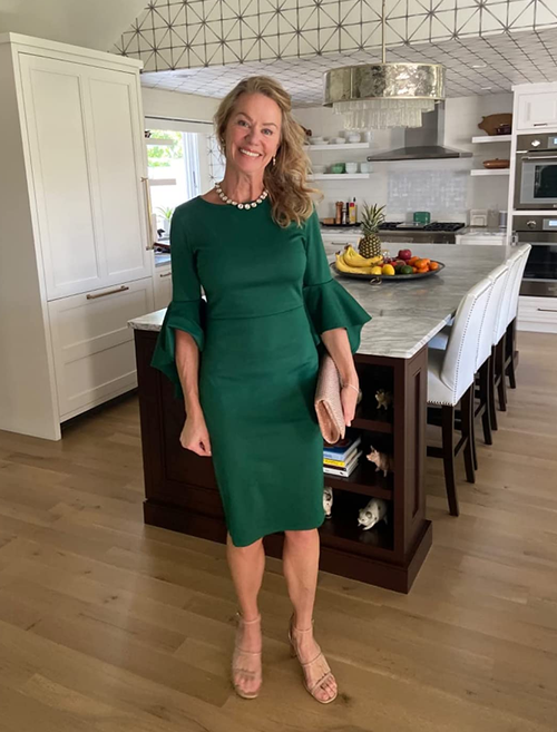 Reviewer is wearing the pencil dress with bell sleeves in green