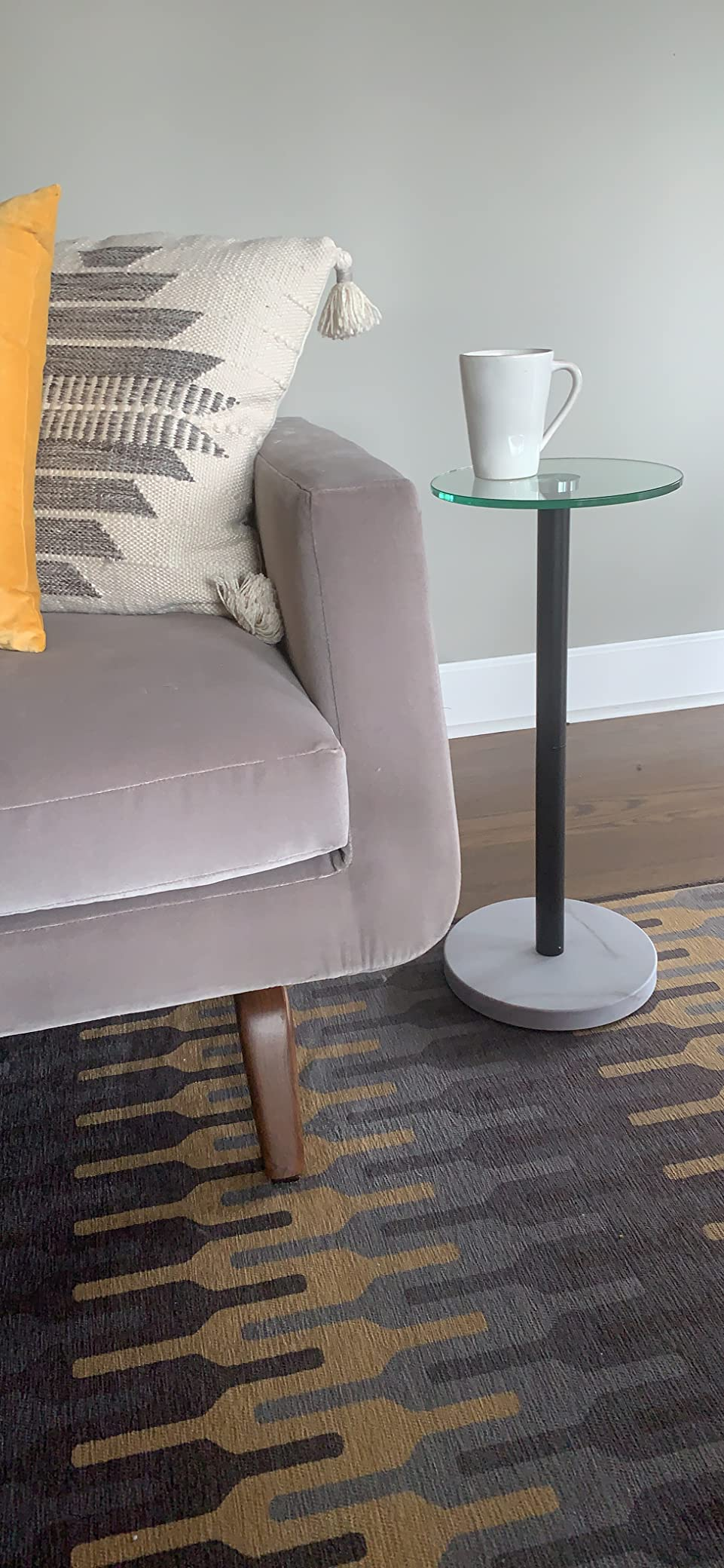 Modern country   with a plush sofa, patterned cushions, and a sleek broadside  array  topped with a mug. Cozy mounting  suggests a relaxed buying  experience