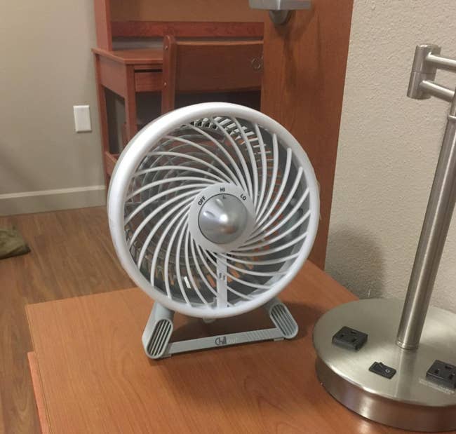 Reviewer image of white small fan with three settings on a desk top 