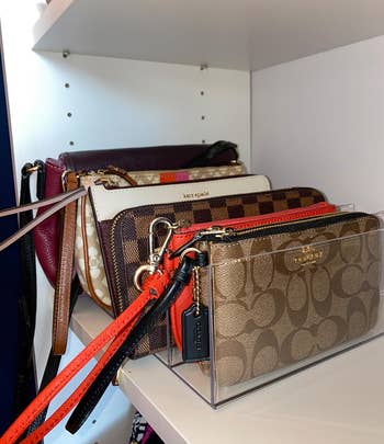 another reviewer's designer handbags by Kate Spade and Coach displayed on the clear organizer