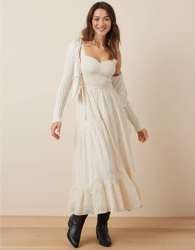 Woman in a flowy maxi dress with a sweetheart neckline and black boots