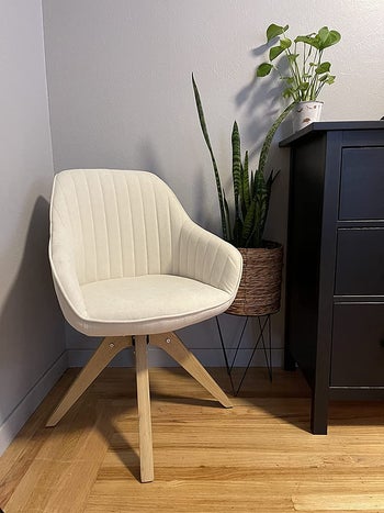 reviewer photo of the white chair in the corner of a bedroom