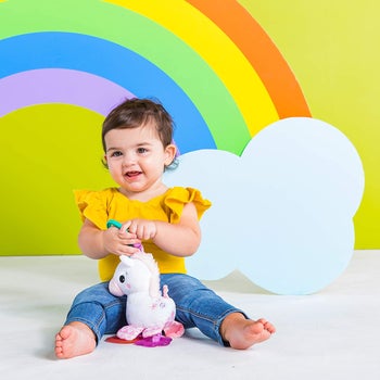 Child playing with the unicorn toy