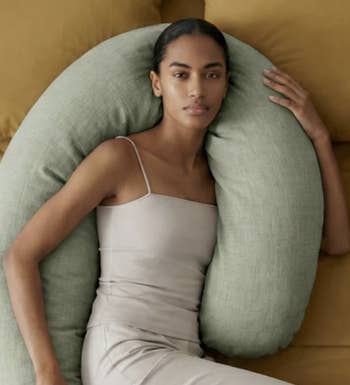 Woman successful  a sleek, sleeveless formal  is relaxing connected  a plush pillow, showcasing a comfy  lounging option