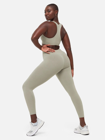 a model wearing the organic stretch legging in the color sage