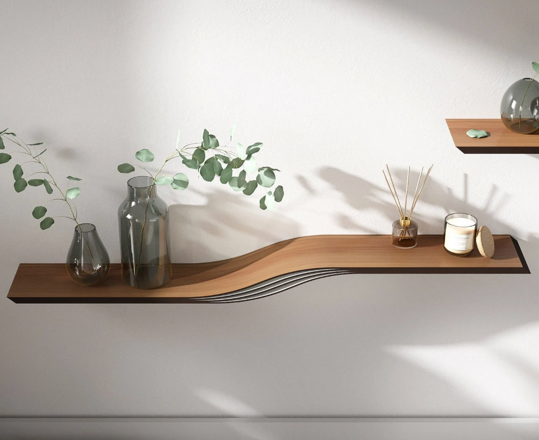 Wooden curved floating shelf on a white wall with pots and two candles on top